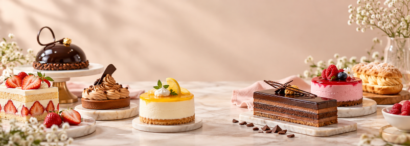 Entremets, cheesecakes, tarts and eclairs on marble